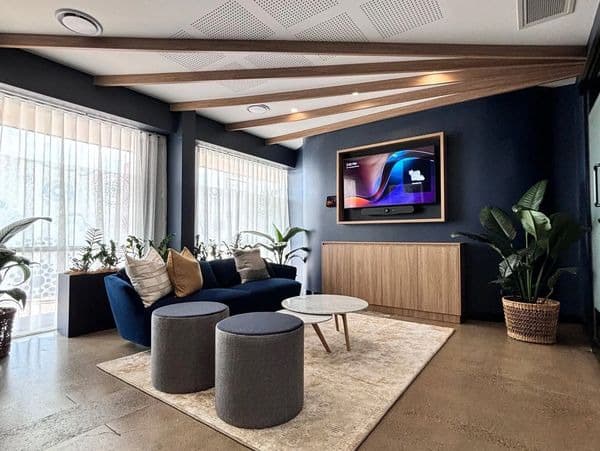 Breakout lounge with lined walls and a raked acoustic ceiling
