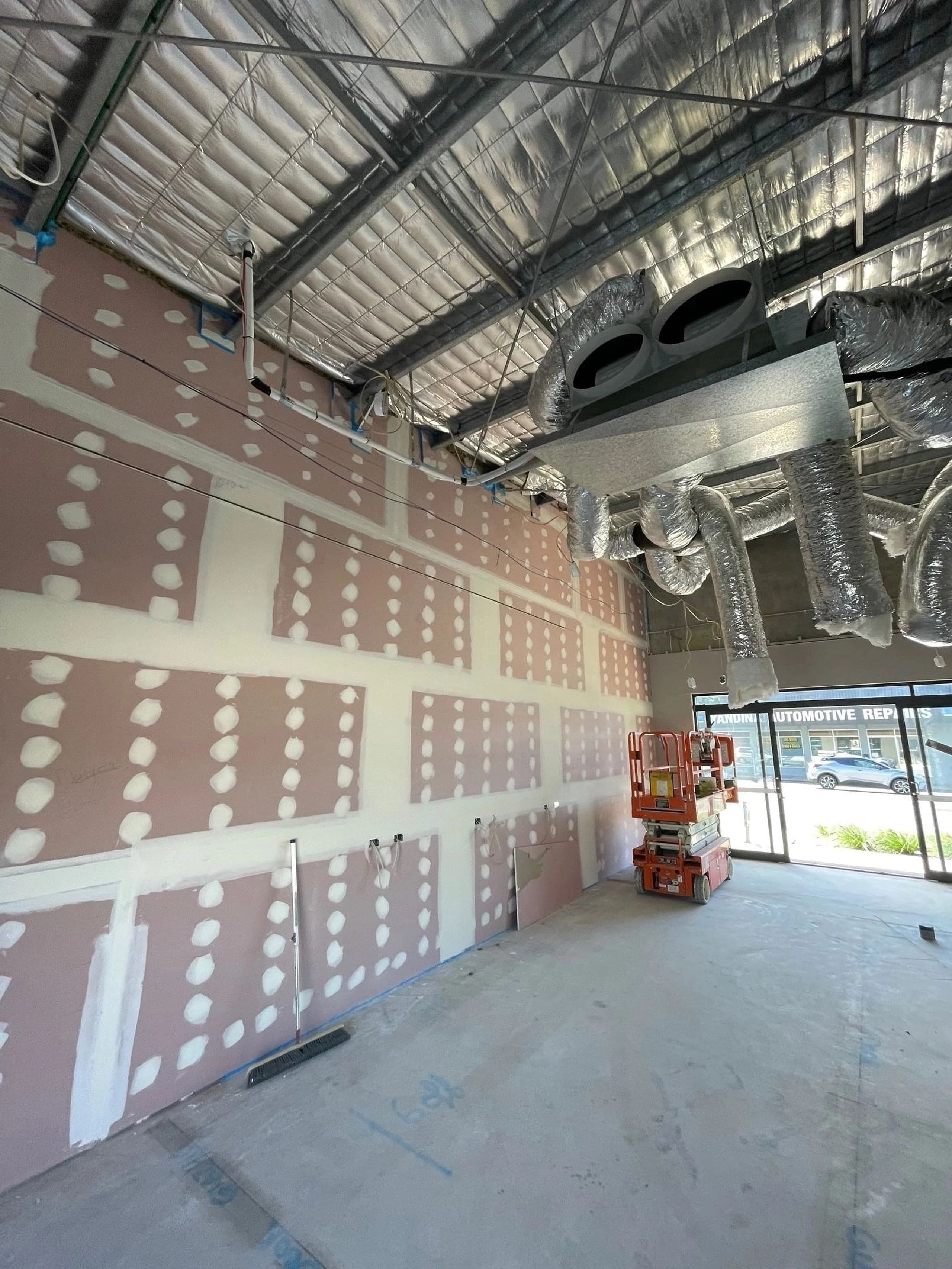 Fire-rated plasterboard wall lining with joints and fixings set, ready for sanding
