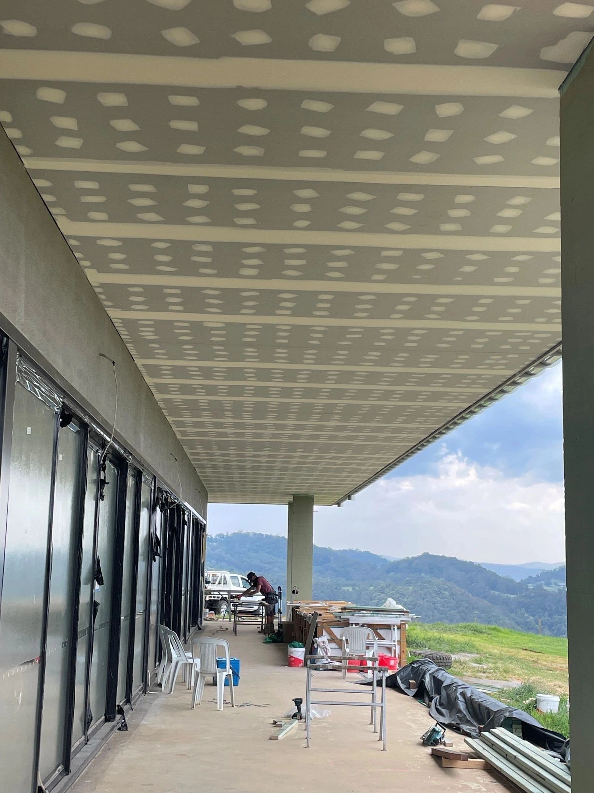 Plasterboard soffit with jointing compound applied over the fixings before sanding